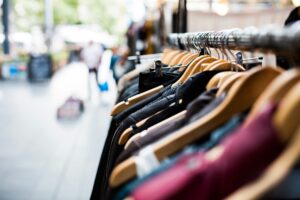 clothing on a rack on the sidewalk