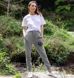 woman wearing organic cotton grey joggers with winged scarab on left thigh