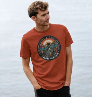 man wearing 'Roots to Riches' t-shirt in rust color