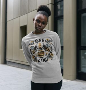 woman wearing the "Bee Kind" Remill swewatshirt in grey