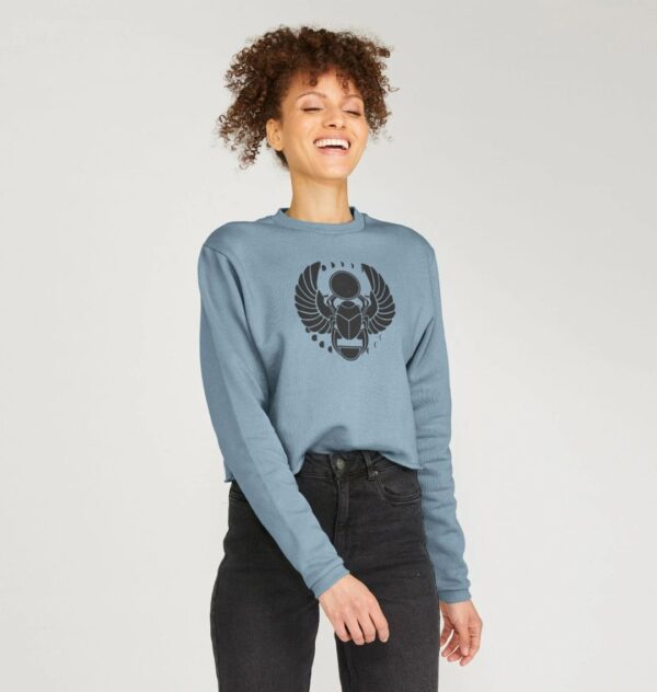 woman wearing the Winged Scarab boxy sweatshirt in blue