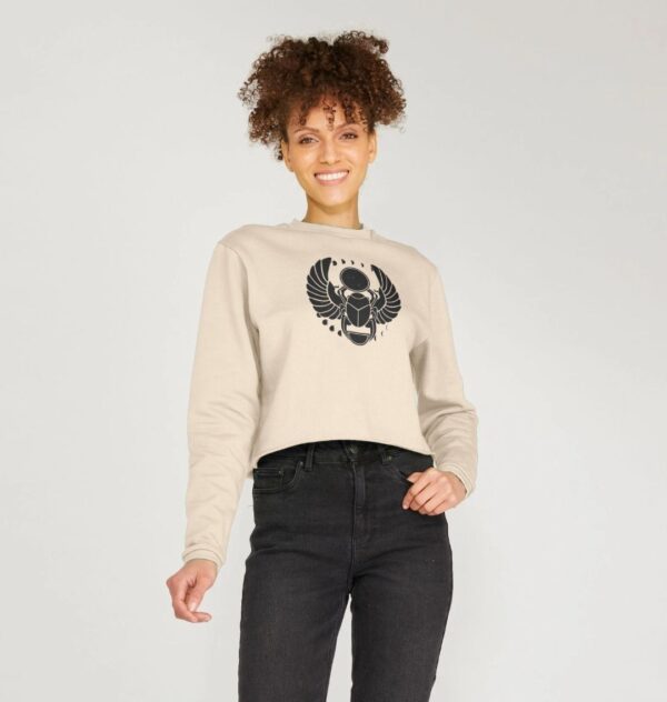 woman wearing the Winged Scarab boxy sweatshirt in oat