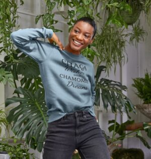 woman wearing "Chaga Wishes and Chamomile Dreams" sweatshirt in stone blue