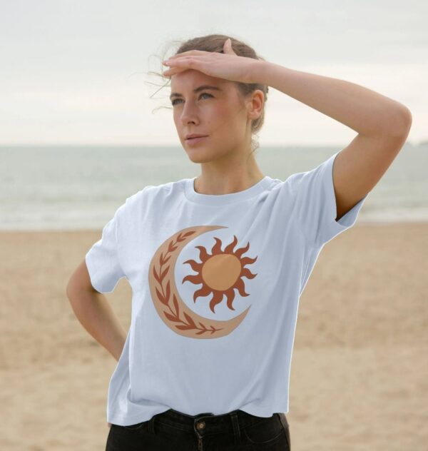 woman wearing organic cotton "Folk Sun and Moon" boxy tee in sky blue color