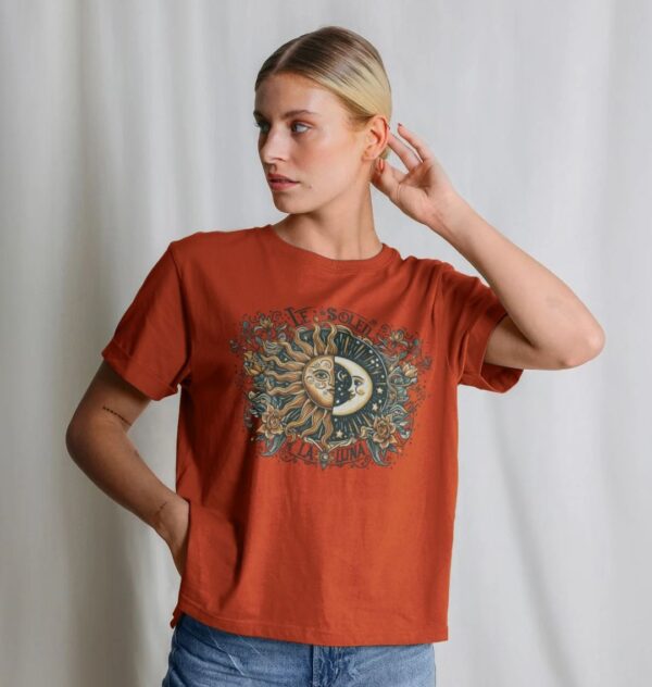 woman wearing organic cotton "Le Soleil La Luna" tee in rust