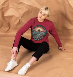 woman wearing "Roots to Riches" organic cotton sweatshirt in cherry color