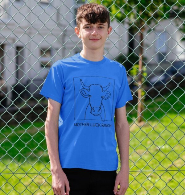 boy wearing the Cowabunga! shirt showing a cow sketch with text "Mother Luck Ranch" in bright blue