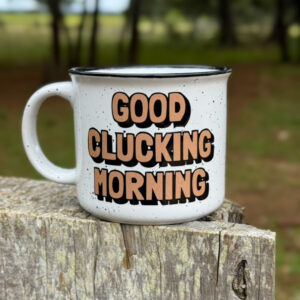 Good Clicking Morning 15 oz. ceramic mug on a fence post
