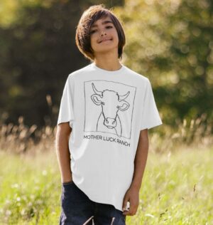 boy wearing the Cowabunga! shirt showing a cow sketch with text "Mother Luck Ranch" in white