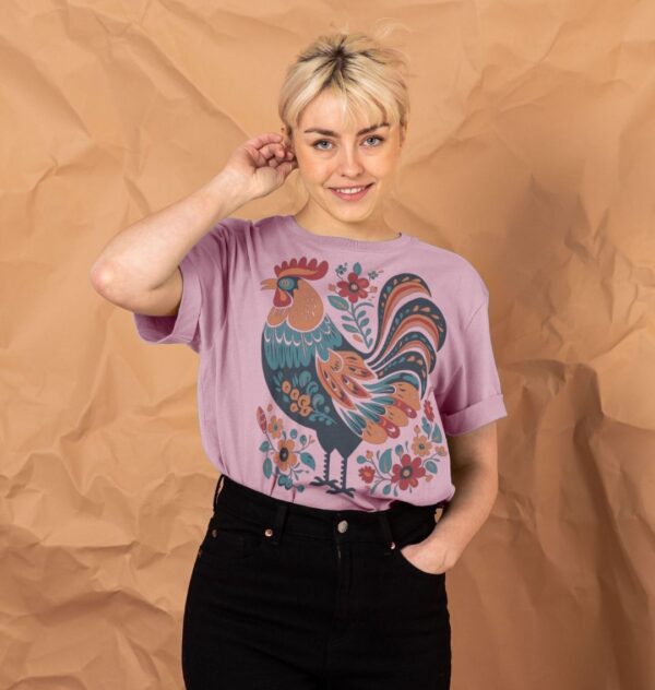 Woman wearing the Women's Folk Art Rooster Organic Cotton Relaxed Tee in Mauve