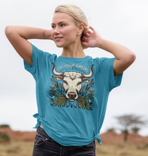 Woman outside wearing the Eat Your Greens Organic Cotton Related Tee in Ocean Blue, with it tied on both sides