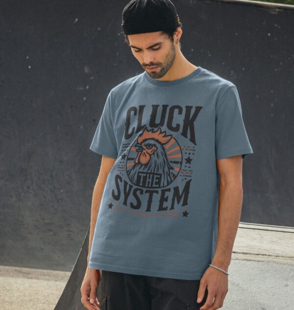 Man in skate park wearing the Men's "Cluck The System" Organic Cotton T-Shirt in Stone Blue