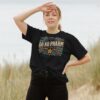 woman by beach wearing the Do No Pharm Organic Cotton Women's Boxy Tee in Black