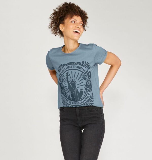 Woman wearing the Stone Blue Organic Cotton T-Shirt "Where Liberty Dwells There Is My Country" Benjamin Franklin Quote