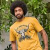 Man wearing the Men's Eat Your Greens Organic Cotton T-Shirt in Mustard Color showcasing a steer eating greens