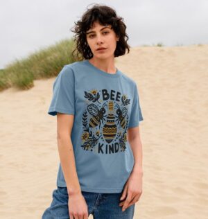 woman on beach wearing the Bee Kind Organic Cotton Women's Classic Tee in Stone Blue Color