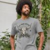 Man wearing the Men's Eat Your Greens Organic Cotton T-Shirt in Athletic Grey Color showcasing a steer eating greens