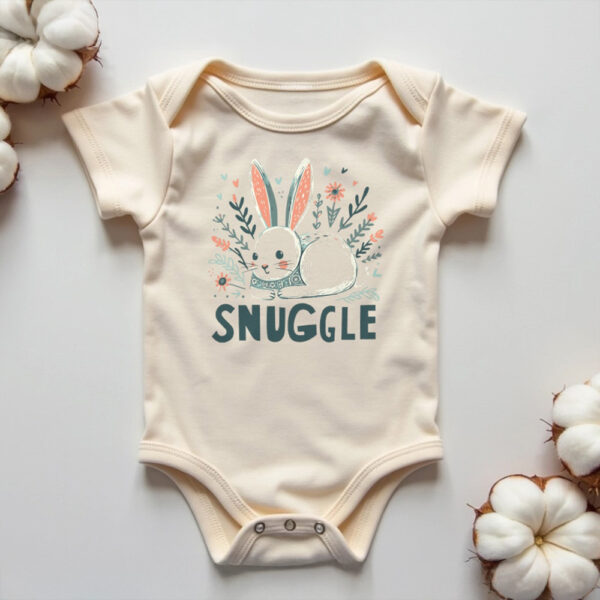 baby onesie with illustration of bunny and word Snuggle on ground with cotton plants on both sides