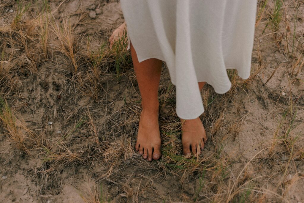 woman standing barefoot on the earth